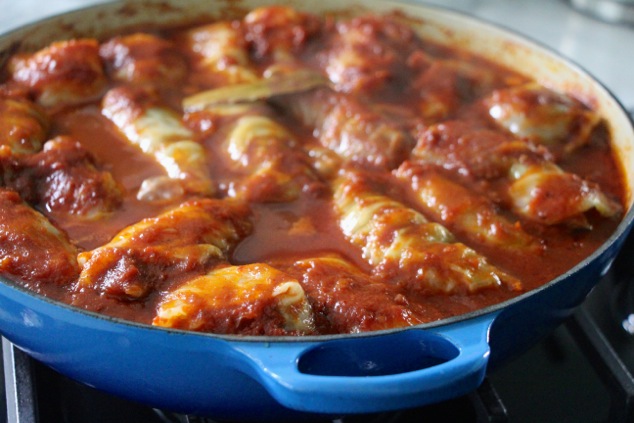 stuffed cabbage cooking in sauce