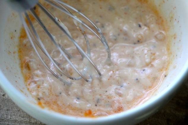 whisking aioli in a bowl