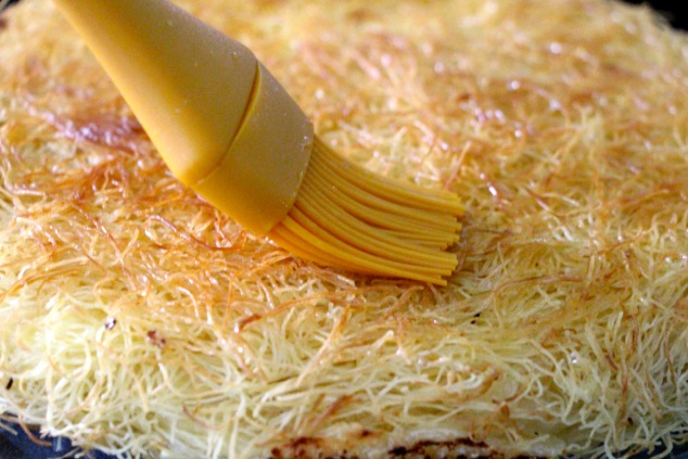 brushing syrup onto Knafeh