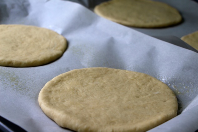 flat dough circles in baking sheet