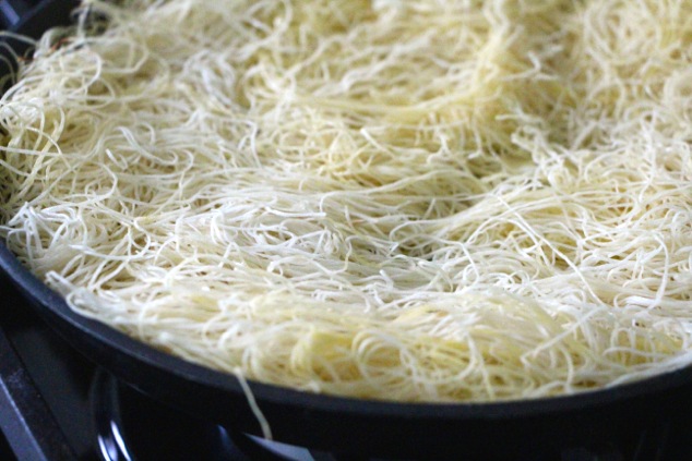 kadaif pastry dough onto pan up close