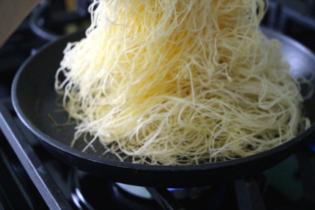 placing kadaif pastry dough onto pan