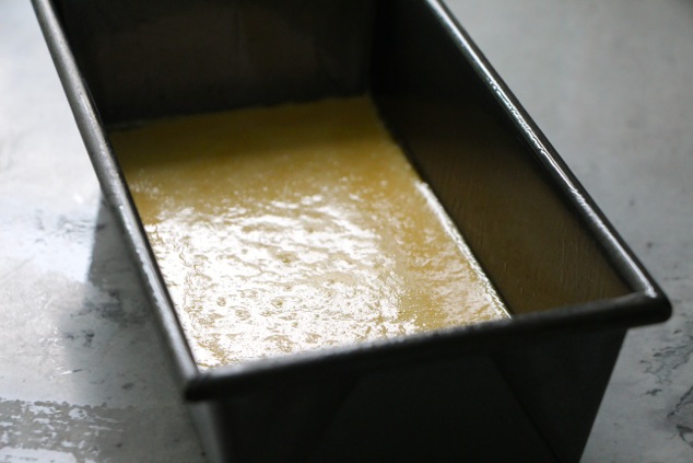 pouring mixture into a loaf pan