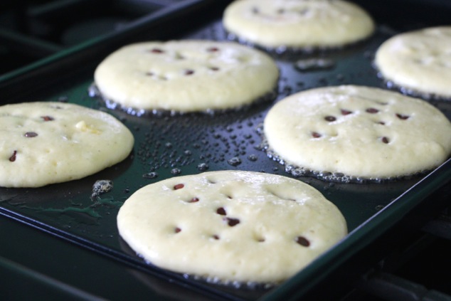 pushing the chocolate chips into the pancakes