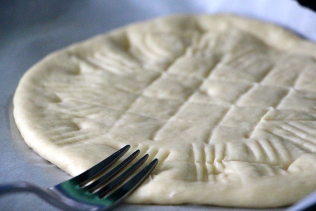 using a fork to create design onto flat bread