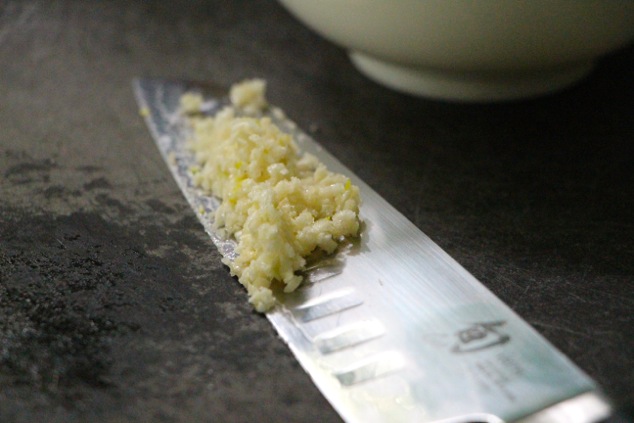 minced garlic on a knife