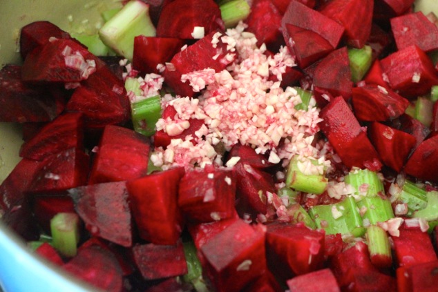 adding minced garlic to pot