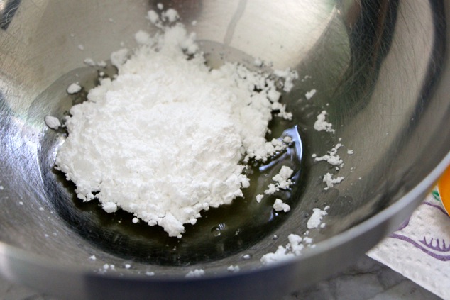 adding powdered sugar to egg white