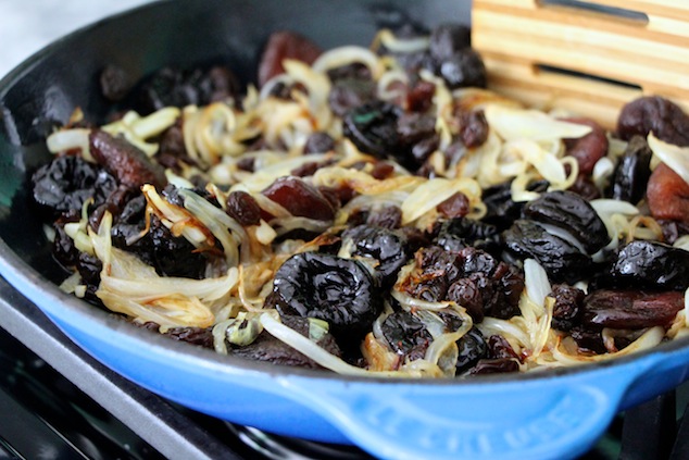 mixing dried fruit into onions