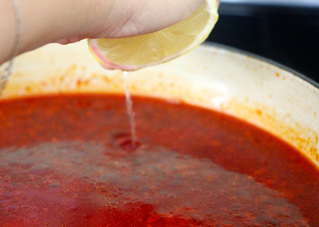 squeezing lemon juice into soup