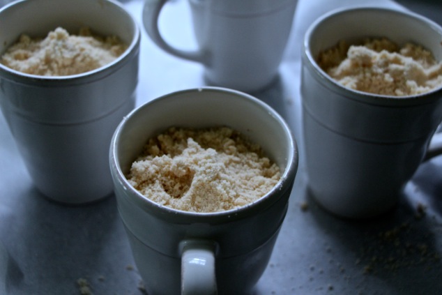 adding the dough crumbs in mugs