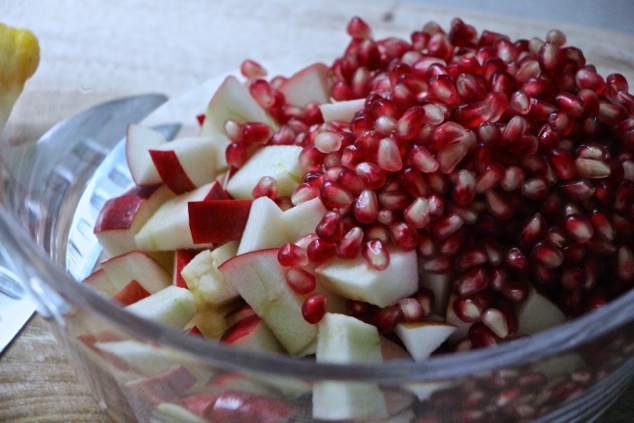 apple cubes and pomegranate seeds in a bowl