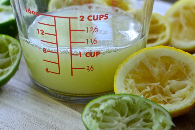 lemon and lime juice in measuring cup up close