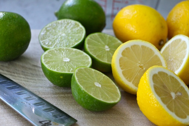 lemons and limes halved on a cutting board