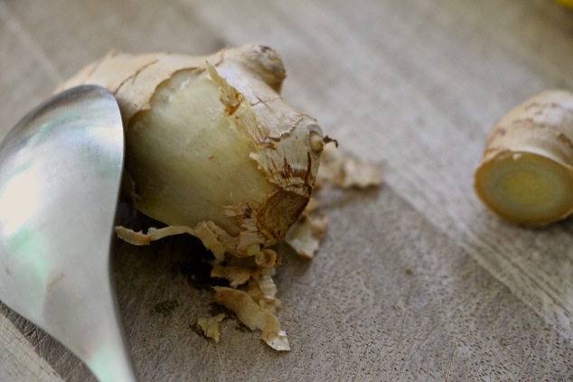 peeling ginger root with spoon