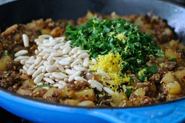 adding chopped parsley lemon zest and pine nuts to hash