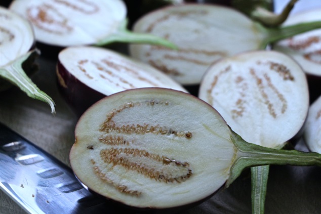 cutting indian eggplants in half