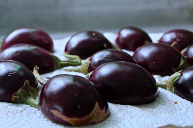 halved eggplants on paper towel