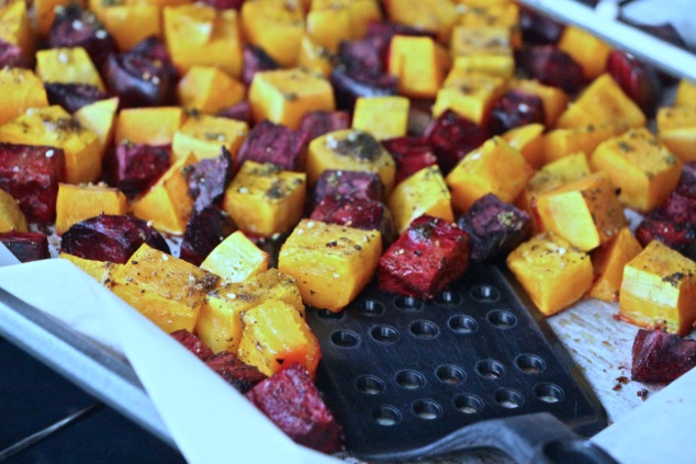 roasting beets and butternut squash on tray with slotted turner