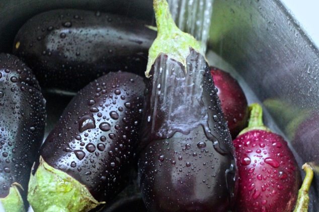 washing eggplants up close