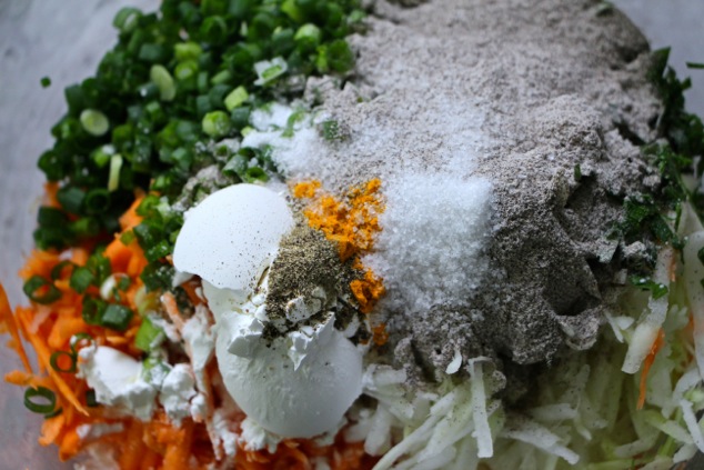 adding spices and flour to latkes ingredients