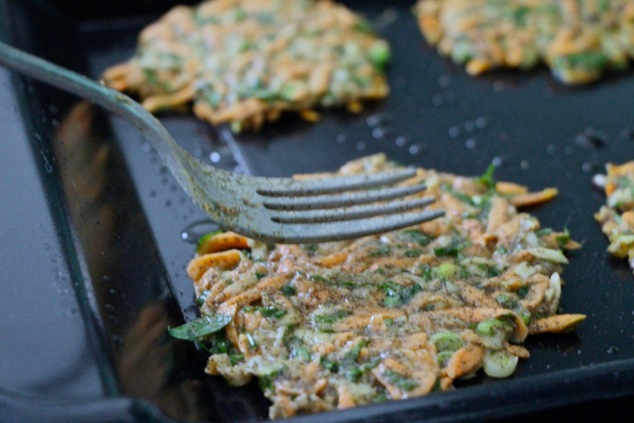 flattening sweet potato kohlrabi latkes onto griddle