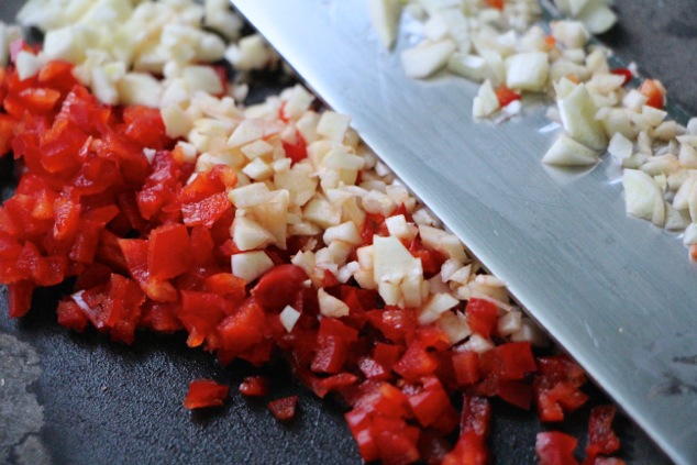 chopping red hot fresno pepper and garlic