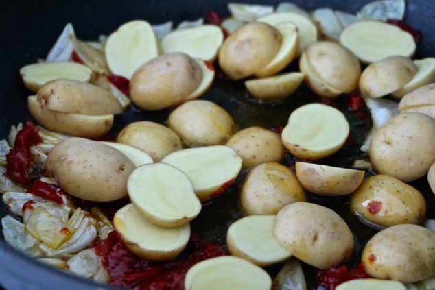 adding baby potatoes to pan
