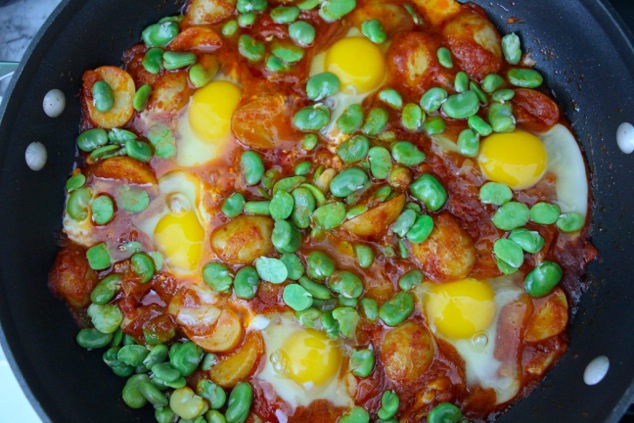 adding blanched fava beans to shakshuka