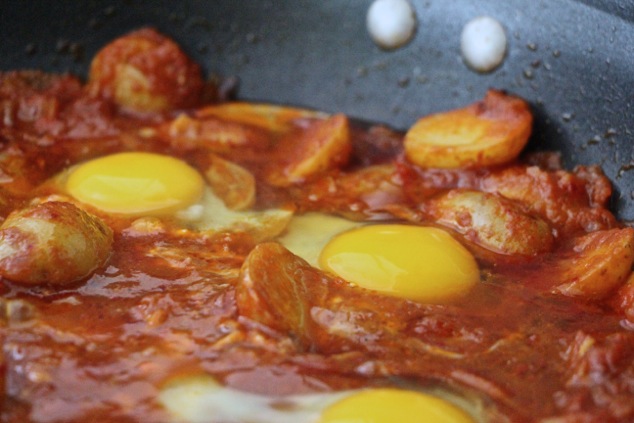 cooking eggs in shakshuka up close