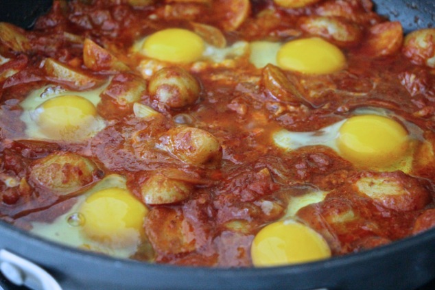 cooking eggs in shakshuka