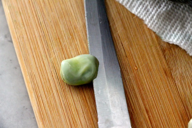 cutting a fava bean out of shell