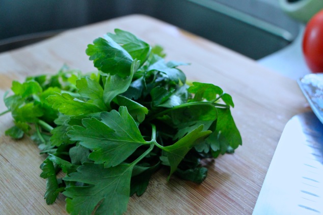 fresh parsley leaves on cutting board