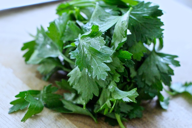 fresh parsley leaves on cutting board