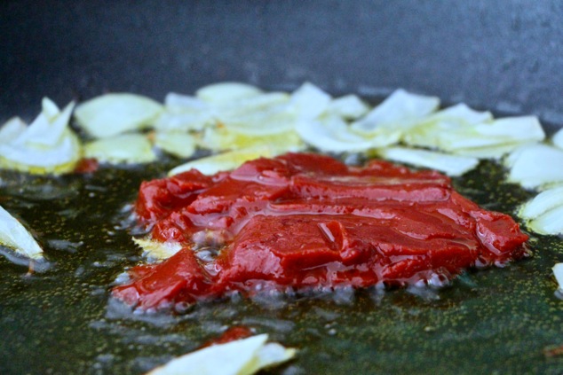 tomato paste sauteing in olive oil up close
