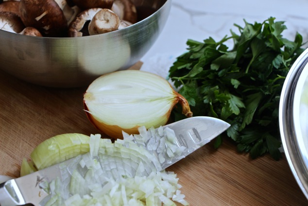 chopped-onion-mushrooms-and-parsley-on-a-cutting-board