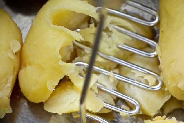 starting-to-mash-boiled-potatoes-close-up