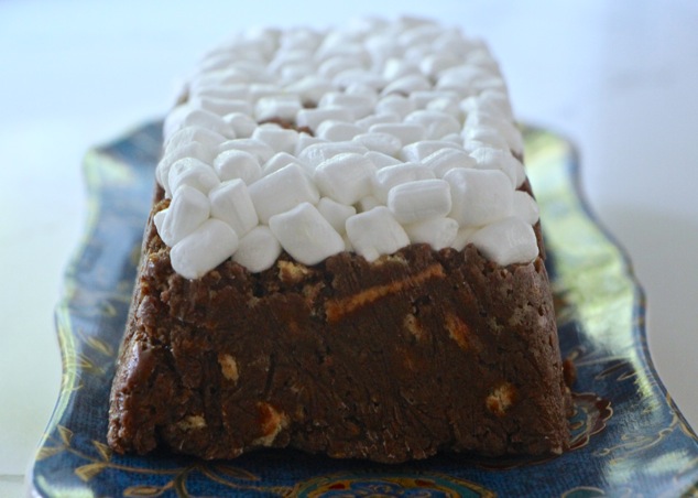 S'mores log cake out of plastic wrap and onto a serving dish