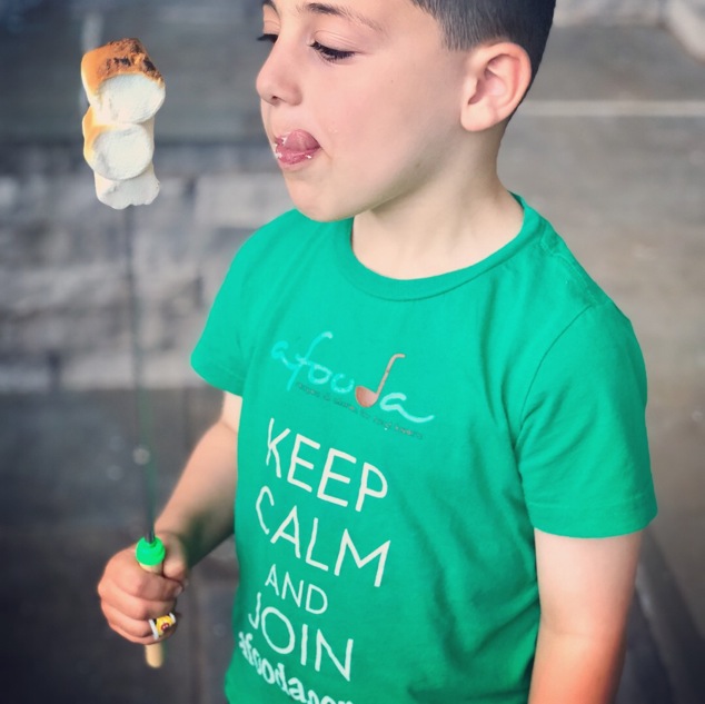 a boy eating roasted marshmallows