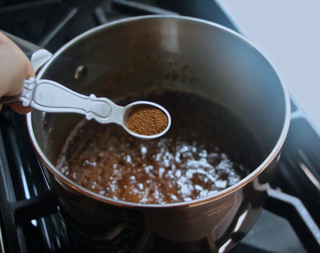 adding coffee powder into saucepan