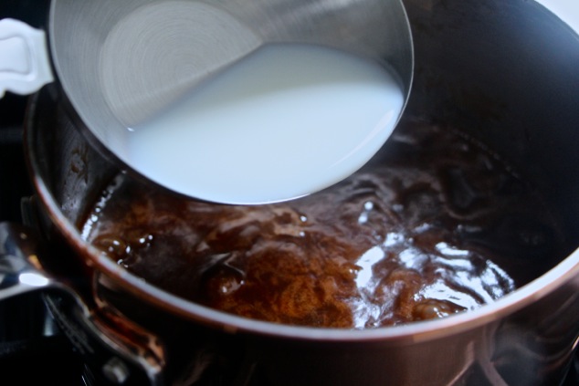 adding milk to fudge in saucepan