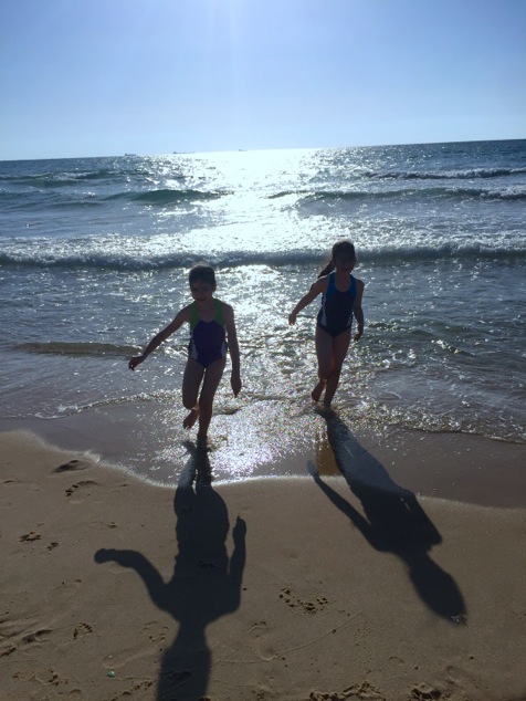 kids running on the beach