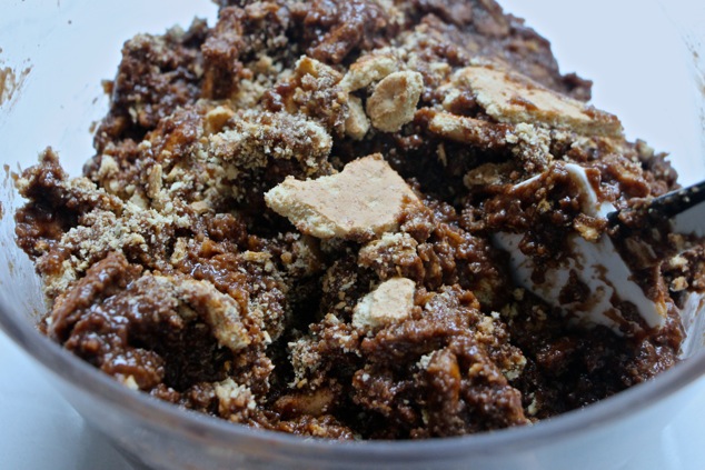 mixing graham crackers and fudge in a bowl