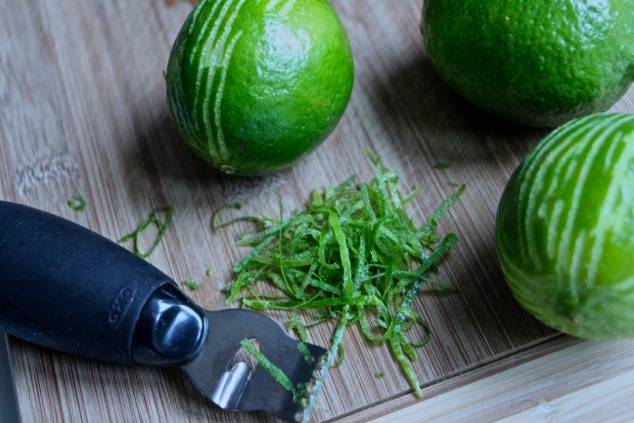 zesting limes on cutting board