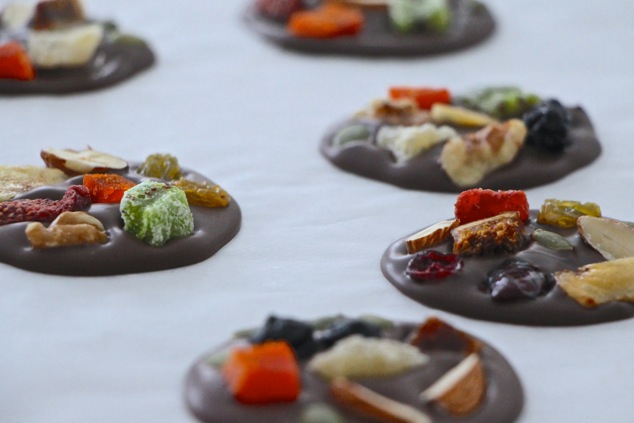 chocolate dried fruit circles setting on partchment paper