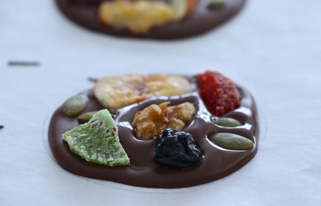 placing the dried fruit and nuts on chocolate circle
