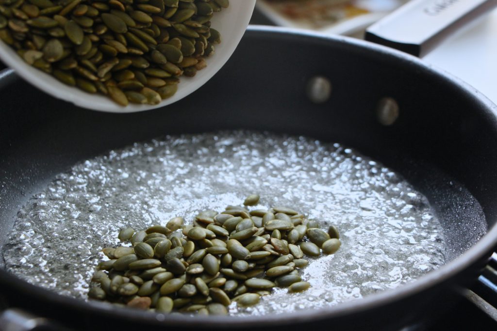 adding pumpkin seeds to sugar syrup