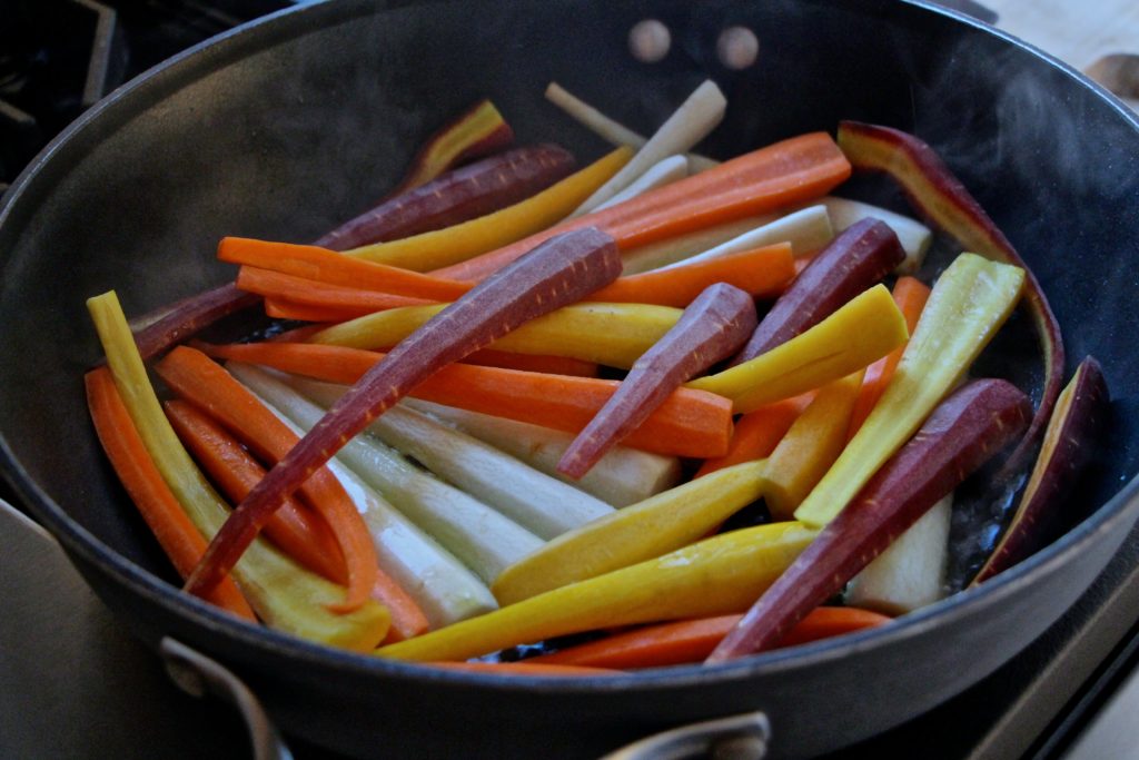 colorful carrots cooking in a pan