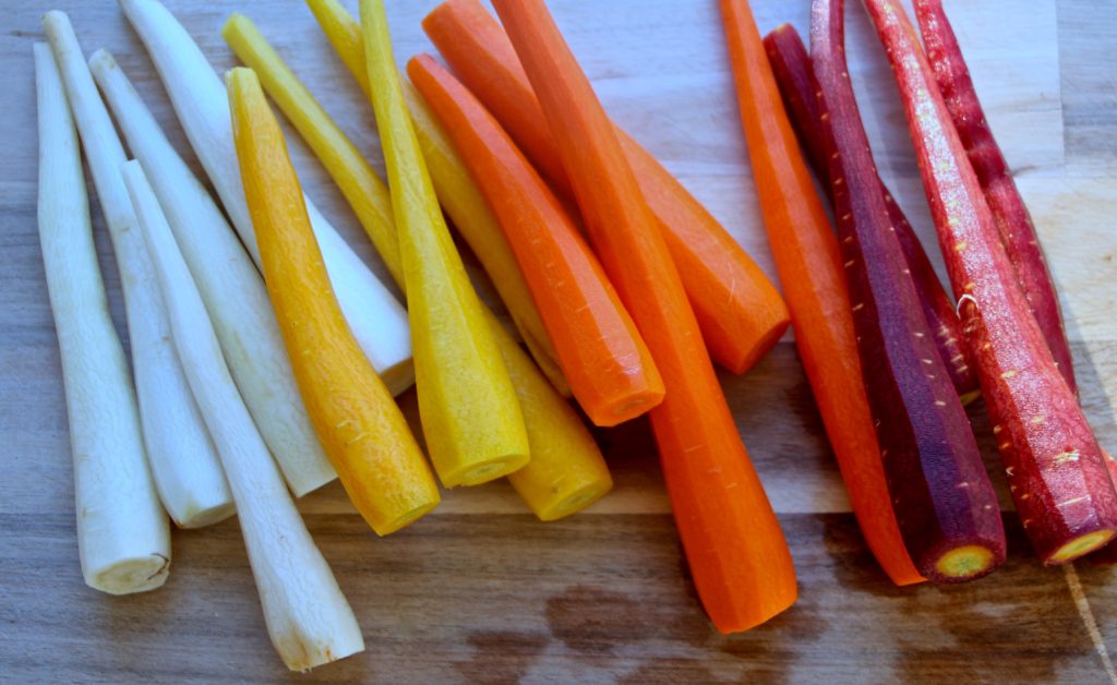 colorful carrots peeled on cutting board